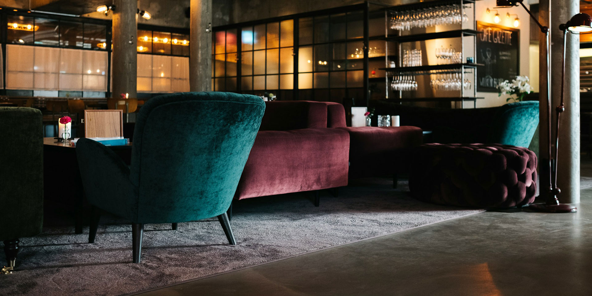 Restaurant lounge interior with teal and burgundy velvet upholstered chairs and carpet flooring Restaurant lounge interior with teal and burgundy velvet upholstered chairs and carpet flooring