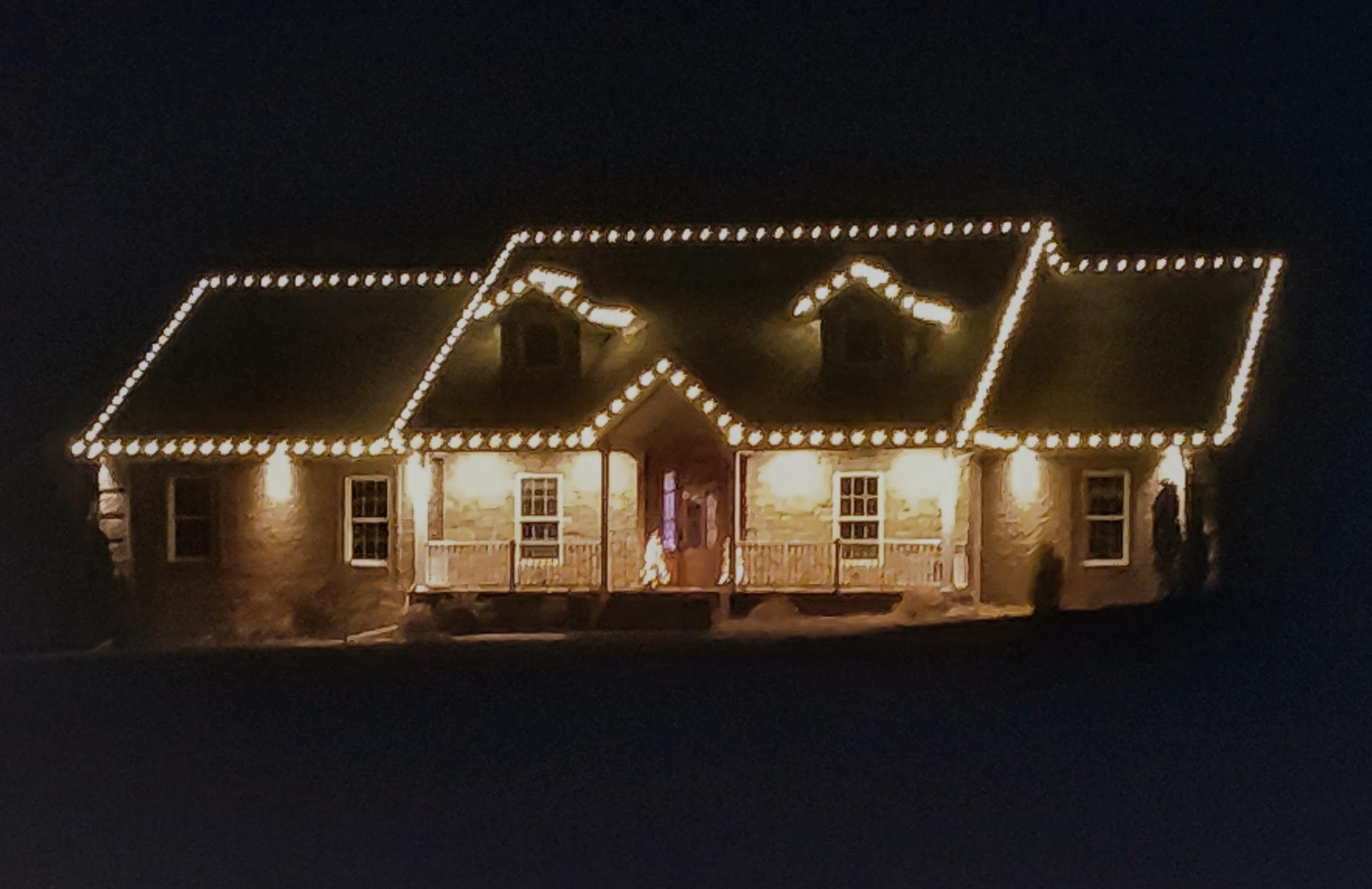 a house with lights warm white lights on it at night in Paducah