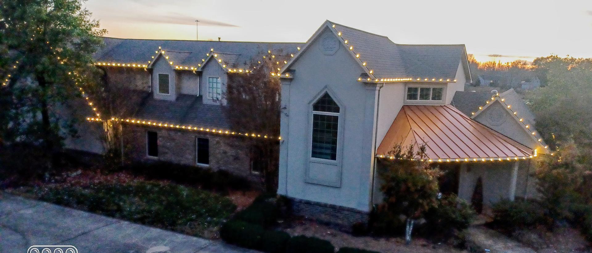 a house with warm white christmas lights on it in Mayfield KY