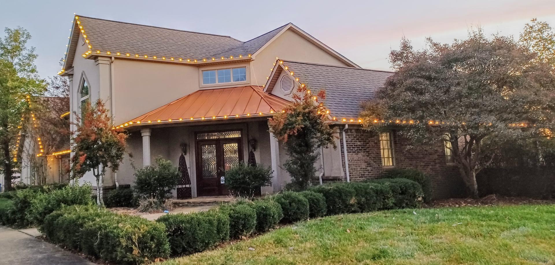 a house with warm white christmas lights in Mayfield KY