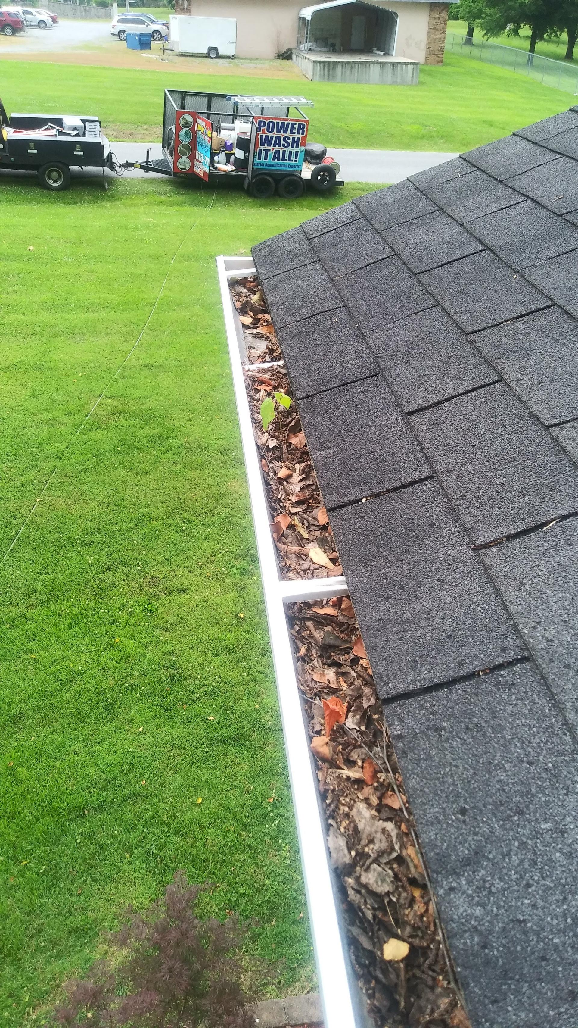 Clogged gutter filled with leaves before gutter cleaning in Reidland, Kentucky Clogged gutter filled with leaves before gutter cleaning in Reidland, Kentucky