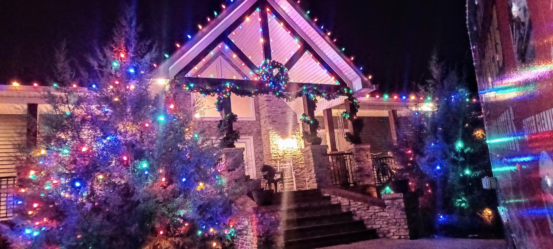 a house with christmas multi color lights in Benton KY