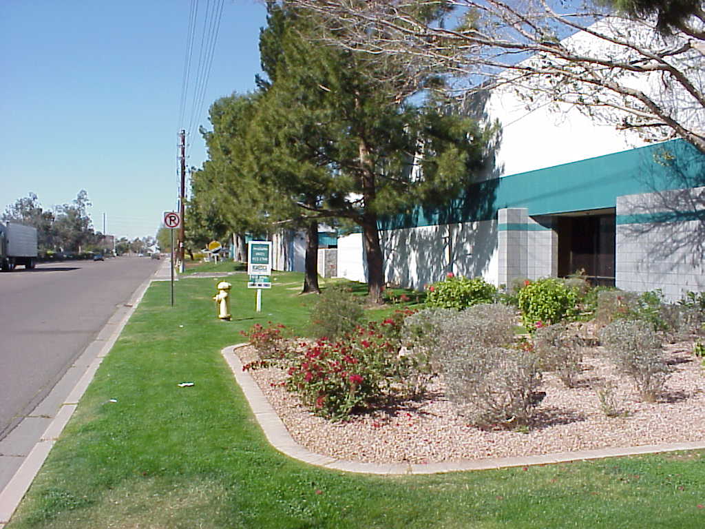 Sidewalk and desert planting bed running alongside an industrial building at Alameda Center Sidewalk and desert planting bed running alongside an industrial building at Alameda Center