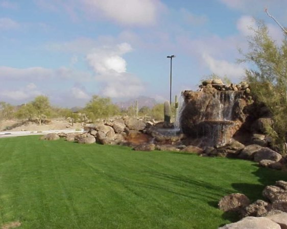 Landscaped yard with turf grass and decorative rock border Landscaped yard with turf grass and decorative rock border