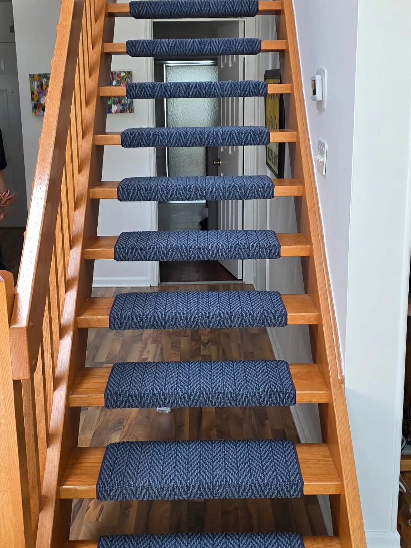 a wooden staircase with blue carpeted steps a wooden staircase with blue carpeted steps