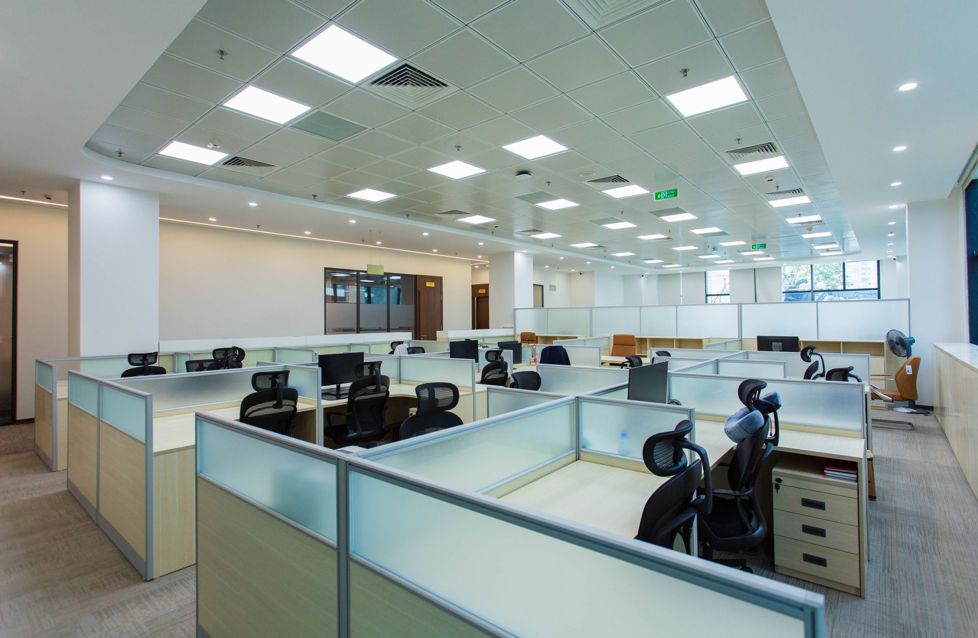 Office space with cubicles on a clean, polished tile floor