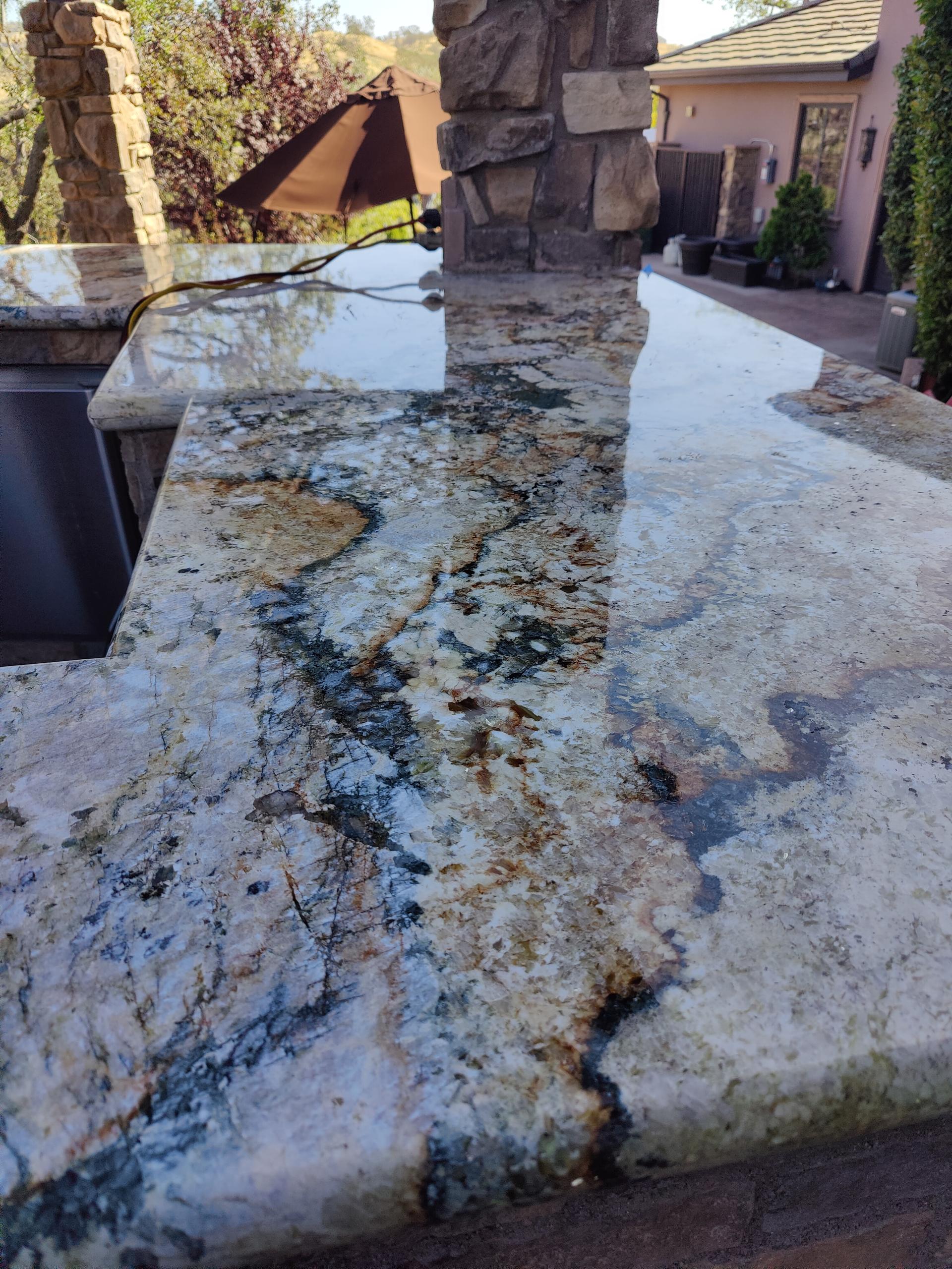 Close-up of an outdoor granite countertop slab with natural mineral veining Close-up of an outdoor granite countertop slab with natural mineral veining