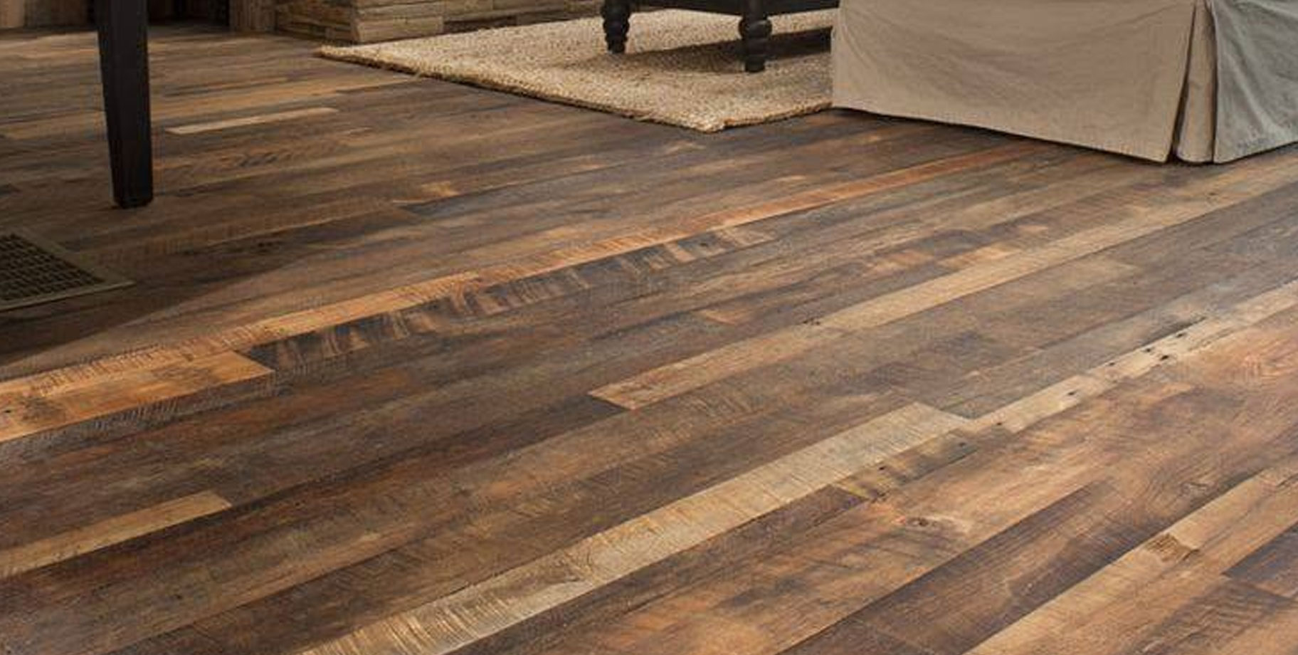 a hardwood floor with a rug and a bed