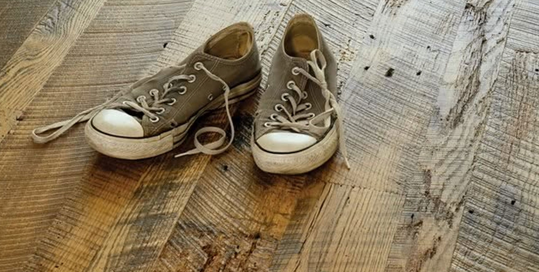 a pair of shoes on a wooden floor a pair of shoes on a wooden floor