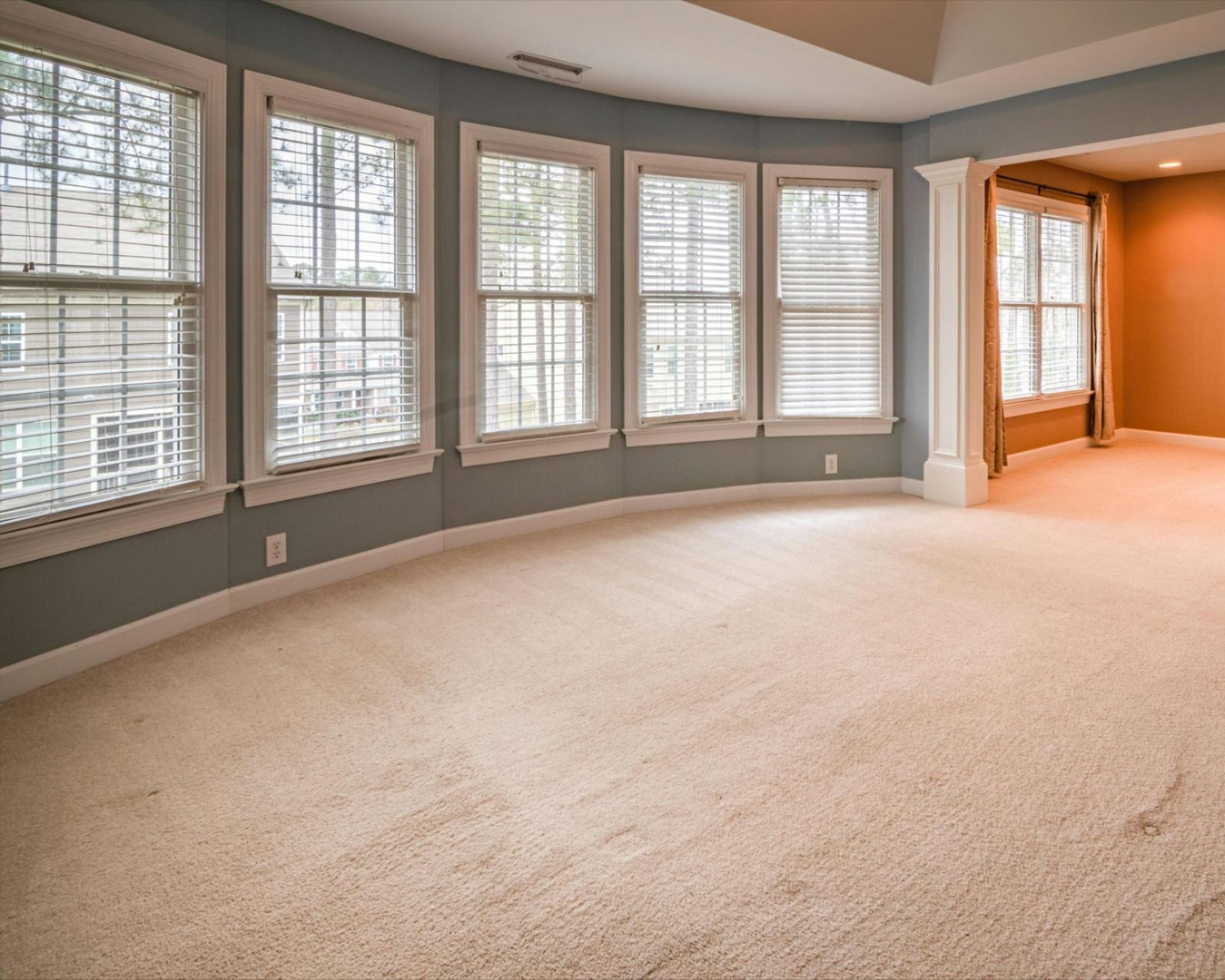 a room with white carpet and windows a room with white carpet and windows