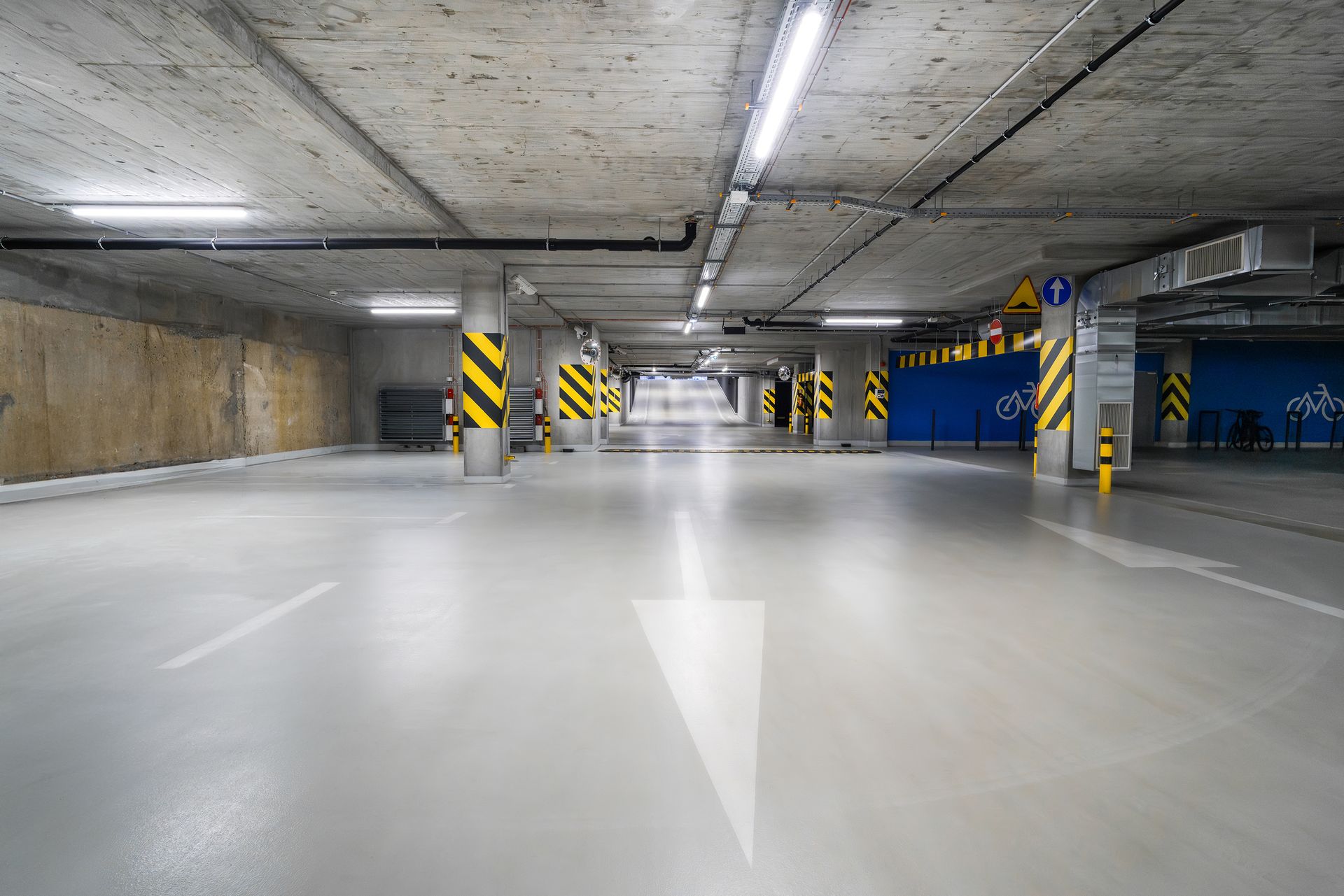 a parking garage with yellow and black stripes a parking garage with yellow and black stripes