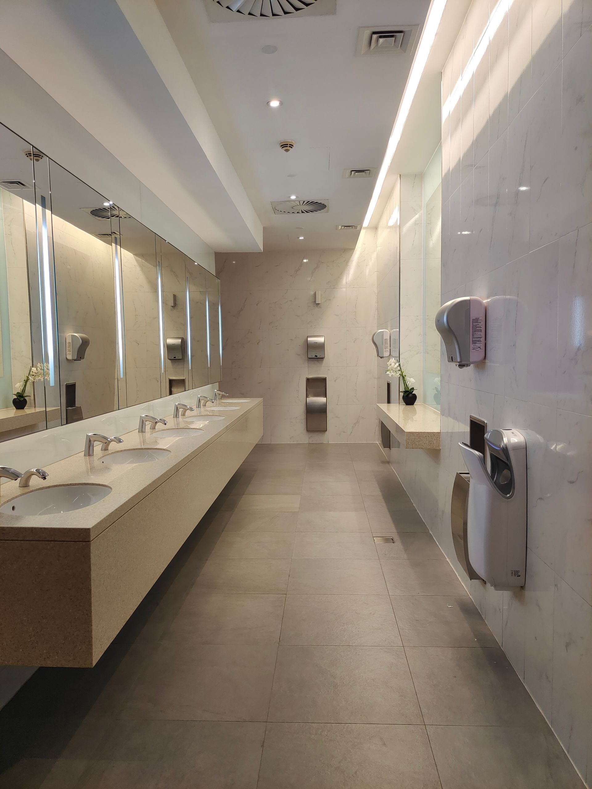 a bathroom with sinks and mirrors