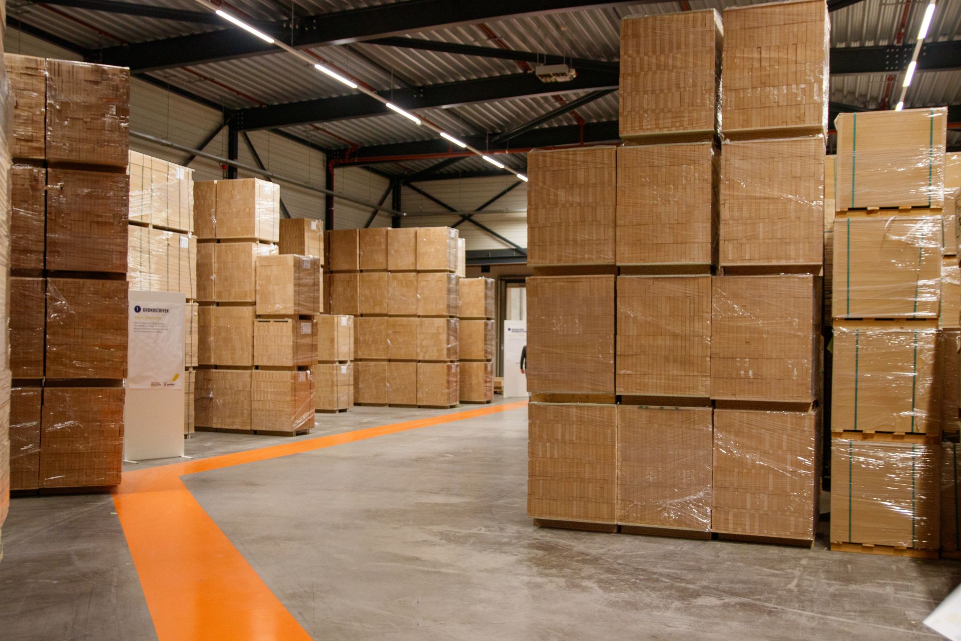 a large warehouse with stacks of boxes a large warehouse with stacks of boxes