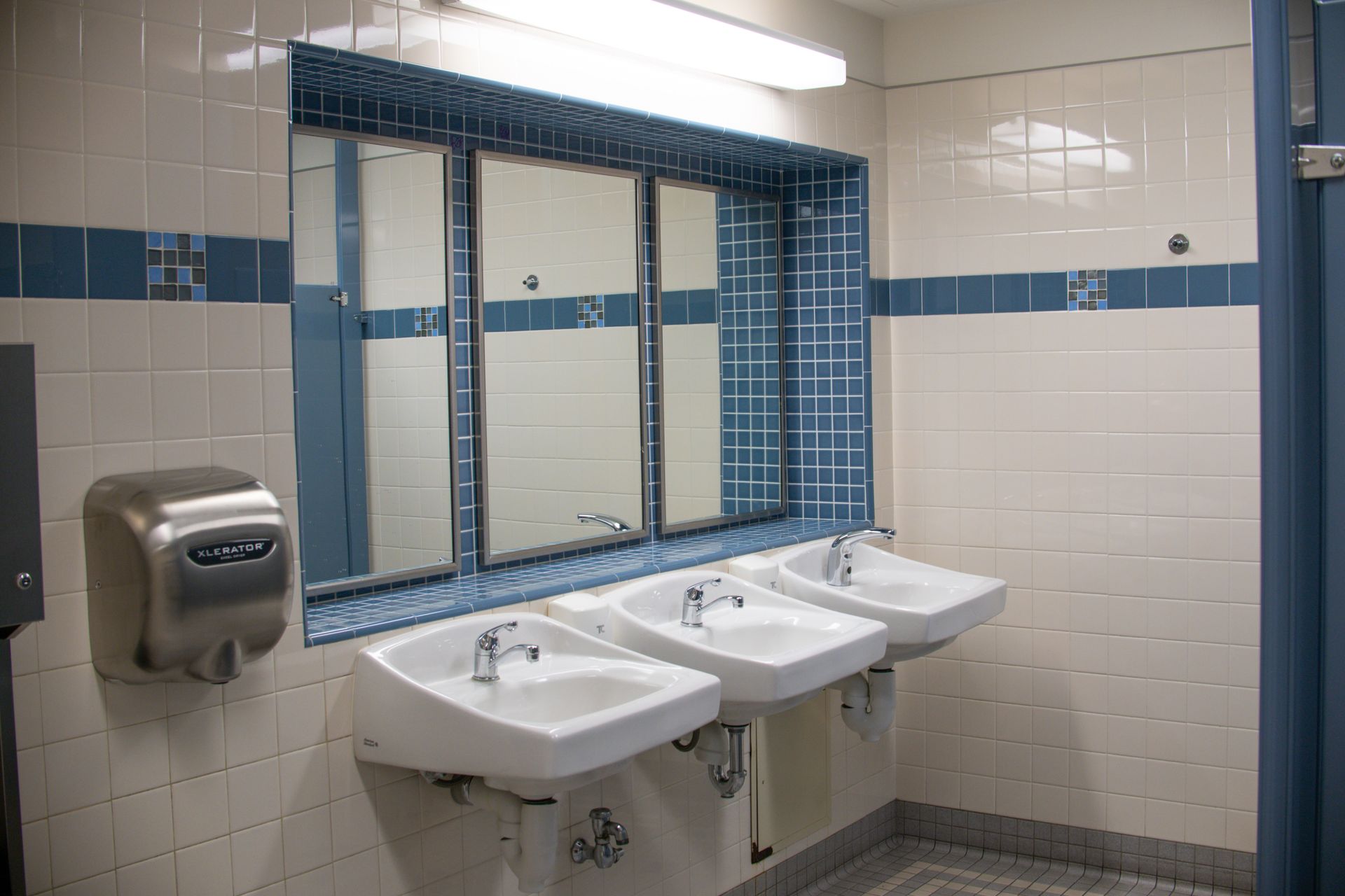 a bathroom with sinks and mirrors