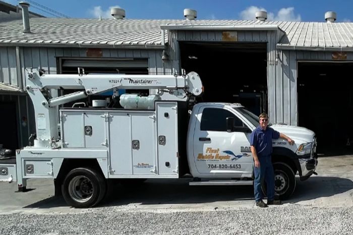 a man standing next to a white truck