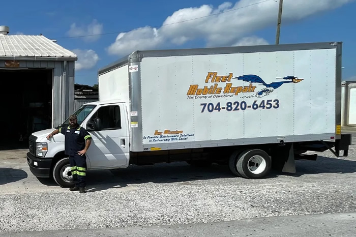 a man standing next to a truck