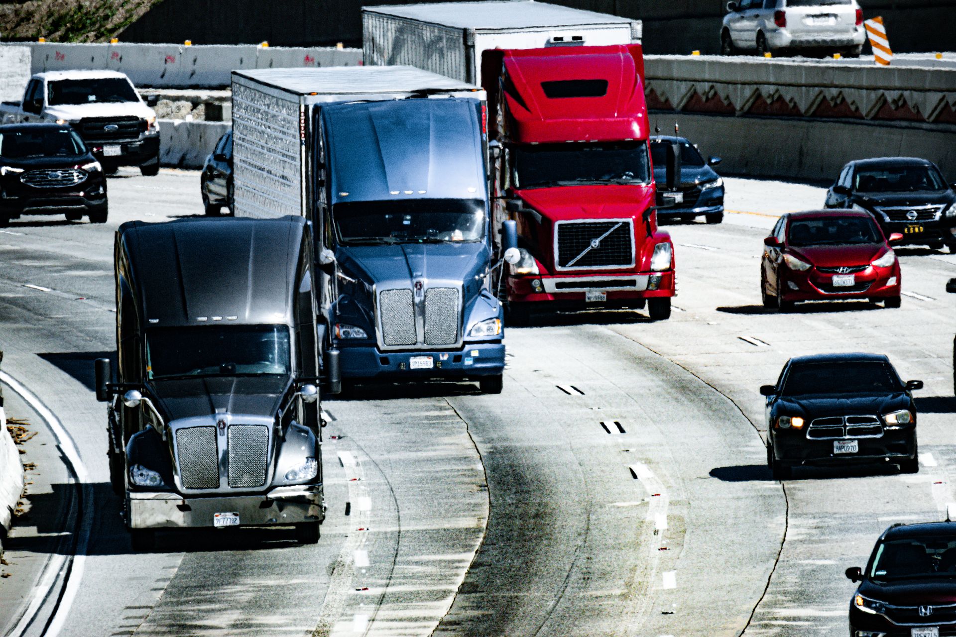 a group of trucks on a highway a group of trucks on a highway