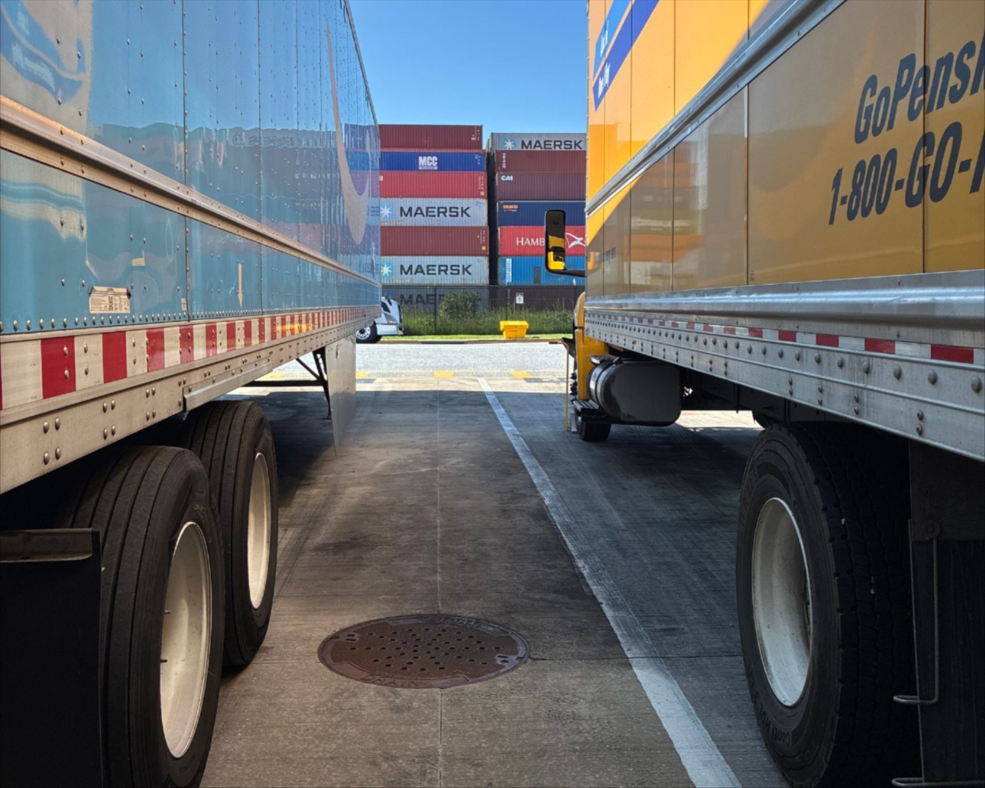 a two semi trucks parked in a parking lot