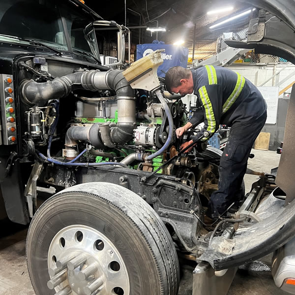 a man working on a truck a man working on a truck