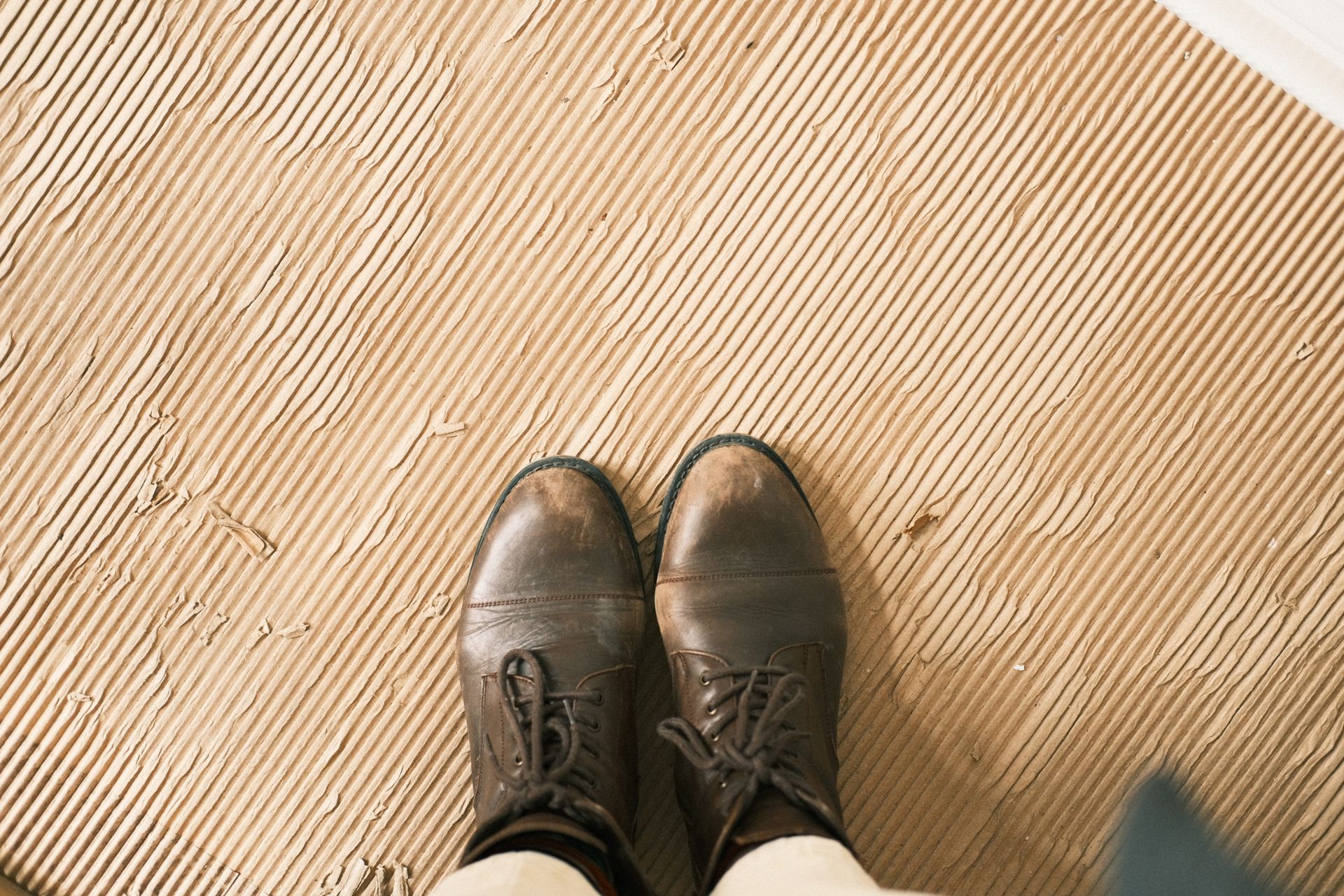 Standing on an exposed subfloor looking down at feet Standing on an exposed subfloor looking down at feet