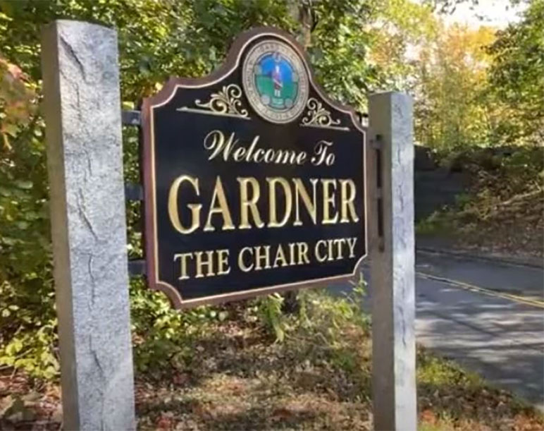 Welcome to Gardner, MA road sign reading "The Chair City," flanked by stone pillars and trees Welcome to Gardner, MA road sign reading "The Chair City," flanked by stone pillars and trees