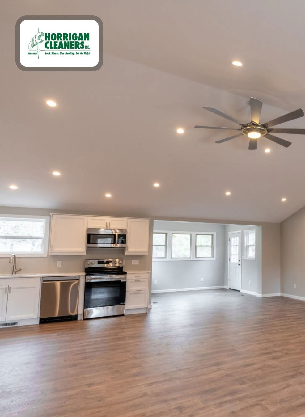 Bright open-concept kitchen with white cabinets and hardwood flooring Bright open-concept kitchen with white cabinets and hardwood flooring